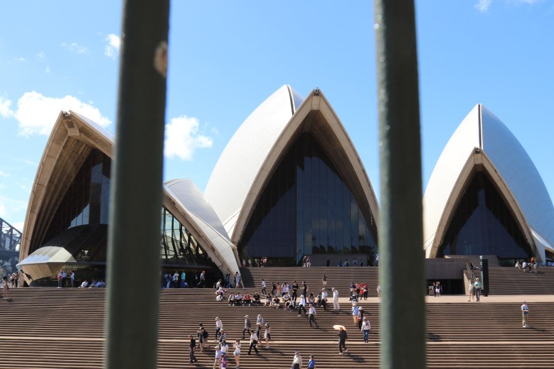 Sydney Opera House through some railings.