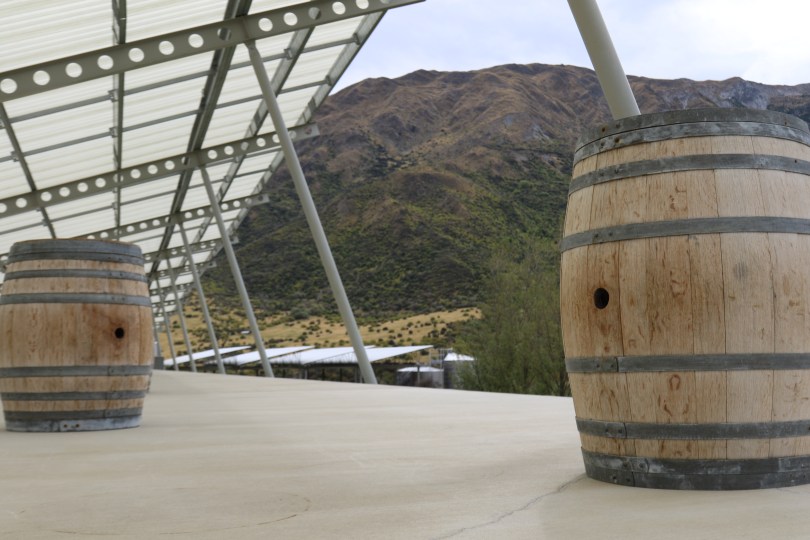 A mountain view with wine barrels at Peregrine Wines in New Zealand.