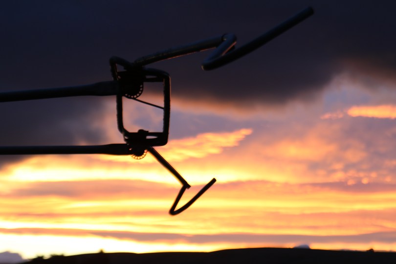 A sunset behind farm equipment at Escarpment winery in New Zealand.